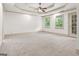 Large main bedroom with a tray ceiling, carpet, and natural light from large windows at 187 Vanira Se Ave, Atlanta, GA 30315
