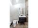 This bathroom showcases an illuminated square mirror, floating vanity, and modern toilet fixture at 2401 Ne Greenglade Rd, Atlanta, GA 30345