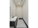 Contemporary powder room featuring sleek vanity, illuminated mirror, and modern fixtures at 2401 Ne Greenglade Rd, Atlanta, GA 30345