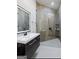 Modern bathroom with a sleek, floating vanity, illuminated mirror, and glass-enclosed shower with rain head at 2401 Ne Greenglade Rd, Atlanta, GA 30345