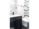 Modern bathroom featuring sleek vanity with stylish fixtures, and unique decorative tile at 2401 Ne Greenglade Rd, Atlanta, GA 30345