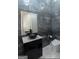 Modern bathroom with gray tile, black fixtures, and a unique vessel sink at 2401 Ne Greenglade Rd, Atlanta, GA 30345