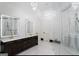 Luxurious bathroom with dual sinks, modern lighting, and a glass-enclosed shower at 2401 Ne Greenglade Rd, Atlanta, GA 30345