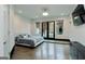 This bedroom features hardwood flooring, three windows, and direct access to an outdoor patio area at 2401 Ne Greenglade Rd, Atlanta, GA 30345