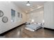 Spacious bedroom featuring hardwood floors, decorative wall accents, and three large windows at 2401 Ne Greenglade Rd, Atlanta, GA 30345