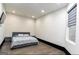 Minimalist bedroom boasts wood flooring, a large window, and simple decor for a serene retreat at 2401 Ne Greenglade Rd, Atlanta, GA 30345