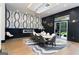 This spacious dining room boasts a decorative wall, modern light fixture, and access to outdoor living at 2401 Ne Greenglade Rd, Atlanta, GA 30345