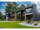 Contemporary home exterior with large windows, dark accents, and lush green landscaping at 2401 Ne Greenglade Rd, Atlanta, GA 30345
