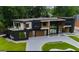 Striking modern home exterior featuring sleek lines, large windows, and a well-manicured lawn at 2401 Ne Greenglade Rd, Atlanta, GA 30345