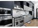 Modern kitchen featuring stainless steel appliances, sleek cabinetry, and stylish backsplash at 2401 Ne Greenglade Rd, Atlanta, GA 30345