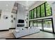 Bright living room with high ceilings, statement chandelier, and expansive windows at 2401 Ne Greenglade Rd, Atlanta, GA 30345