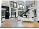 Open-concept living room with soaring ceilings, modern staircase, and lots of natural light at 2401 Ne Greenglade Rd, Atlanta, GA 30345