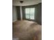 Bright bedroom with a large window, neutral walls, and soft carpet flooring at 2756 Norfair Loop, Lithonia, GA 30038