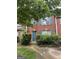Charming red brick townhouse with teal shutters and a well-maintained front yard at 2756 Norfair Loop, Lithonia, GA 30038