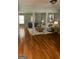 Staged living room with hardwood floors, neutral walls, sofa, two chairs, and artful decor at 2756 Norfair Loop, Lithonia, GA 30038