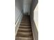 Carpeted staircase with white railing and neutral gray walls, leading to the upper level at 2756 Norfair Loop, Lithonia, GA 30038