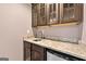 Beverage bar featuring granite countertops, custom cabinets and mini refrigerator at 5825 Trailwood Ct, Suwanee, GA 30024