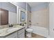 Bathroom with granite countertop vanity, framed mirror, tiled shower over tub, and neutral color scheme at 5825 Trailwood Ct, Suwanee, GA 30024
