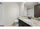 Functional bathroom featuring a granite countertop vanity, dark cabinets, and shower at 5825 Trailwood Ct, Suwanee, GA 30024