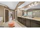 Bathroom showcasing a spacious granite double vanity with large mirror at 5825 Trailwood Ct, Suwanee, GA 30024