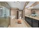 Bathroom featuring a tiled walk-in shower, a tub, and double vanity at 5825 Trailwood Ct, Suwanee, GA 30024