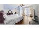 Spacious bedroom with hardwood floors, ceiling fan, and a window with coverings at 5825 Trailwood Ct, Suwanee, GA 30024