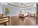 Bedroom featuring tray ceiling, hardwood floors, and natural light at 5825 Trailwood Ct, Suwanee, GA 30024