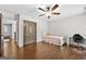 Bedroom featuring hardwood floors, desk, and closet space at 5825 Trailwood Ct, Suwanee, GA 30024