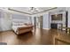 Primary bedroom boasts a beverage bar, ensuite bath, tray ceiling and hardwood floors at 5825 Trailwood Ct, Suwanee, GA 30024