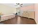 Bright bedroom featuring hardwood floors, natural light, and ample closet space at 5825 Trailwood Ct, Suwanee, GA 30024