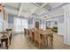 Charming dining room featuring elegant decor, wainscoting, coffered ceilings, and a modern chandelier at 5825 Trailwood Ct, Suwanee, GA 30024