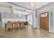 Formal dining area featuring coffered ceilings, natural light, wainscoting, a table and front door at 5825 Trailwood Ct, Suwanee, GA 30024