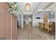 View of foyer with hardwood floors leading to an elegant dining area featuring a modern chandelier at 5825 Trailwood Ct, Suwanee, GA 30024