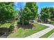 Beautifully landscaped front yard with lush green lawn and mature trees surrounding a brick home at 5825 Trailwood Ct, Suwanee, GA 30024