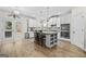 Open kitchen with white cabinets, stainless steel appliances, a center island with seating, and access to the backyard at 5825 Trailwood Ct, Suwanee, GA 30024