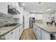 Well-equipped kitchen showcasing stainless steel appliances, granite countertops, an island, and ample cabinet space at 5825 Trailwood Ct, Suwanee, GA 30024