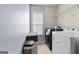 Convenient laundry room with a washer, dryer, and a storage shelf at 5825 Trailwood Ct, Suwanee, GA 30024