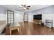 Living room showcasing hardwood floors, ceiling fan, and wall paneling at 5825 Trailwood Ct, Suwanee, GA 30024