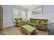 Bright living room featuring hardwood floors, wainscoting, and olive green furniture at 5825 Trailwood Ct, Suwanee, GA 30024