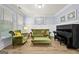 Bright living room with wainscoting, hardwood floors, and a black piano at 5825 Trailwood Ct, Suwanee, GA 30024