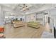 Open-concept living room with hardwood floors, coffered ceilings, and white kitchen at 5825 Trailwood Ct, Suwanee, GA 30024