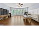 Spacious living room featuring hardwood floors, ceiling fan, and bright windows at 5825 Trailwood Ct, Suwanee, GA 30024