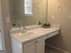 Neutral bathroom with a white vanity, large mirror, and a white countertop with small decorative plant at 5400 Twin Lakes Dr, South Fulton, GA 30349