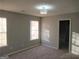Bedroom with large windows offering plenty of natural light and gray walls and carpet at 5400 Twin Lakes Dr, South Fulton, GA 30349