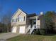 Charming two-story home with attached two-car garage and well-maintained front lawn at 5400 Twin Lakes Dr, South Fulton, GA 30349