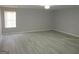 Spacious living room with neutral walls, hardwood floors, and a large window providing ample natural light at 5400 Twin Lakes Dr, South Fulton, GA 30349