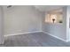 Living room with light gray walls and flooring and a partial view into the kitchen area at 5400 Twin Lakes Dr, South Fulton, GA 30349