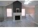 Living room with vaulted ceilings, light gray walls and flooring, and a fireplace creating a cozy atmosphere at 5400 Twin Lakes Dr, South Fulton, GA 30349