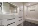 Modern bathroom featuring a lighted mirror, large vanity, and tiled shower and tub at 4959 Abbotts Glen Nw Trl, Acworth, GA 30101