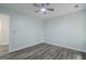 Light-filled bedroom featuring a ceiling fan, neutral paint, and stylish wood-look flooring at 4959 Abbotts Glen Nw Trl, Acworth, GA 30101